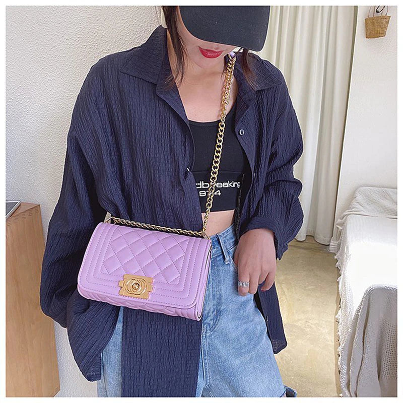 purple handbag with gold detail