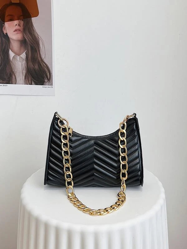 black textured bag with gold chain detail
