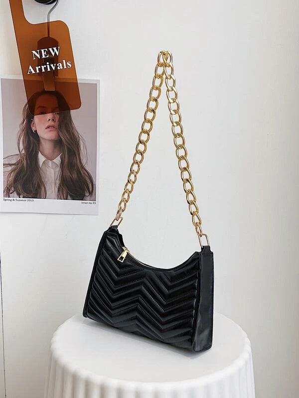 ladies black textured bag with gold chain detail