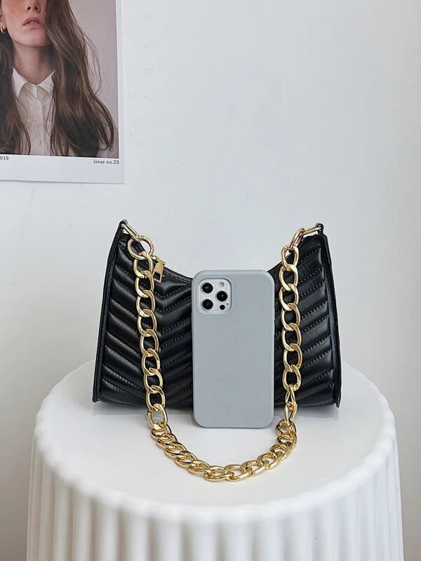 ladies black textured bag with gold chain strap