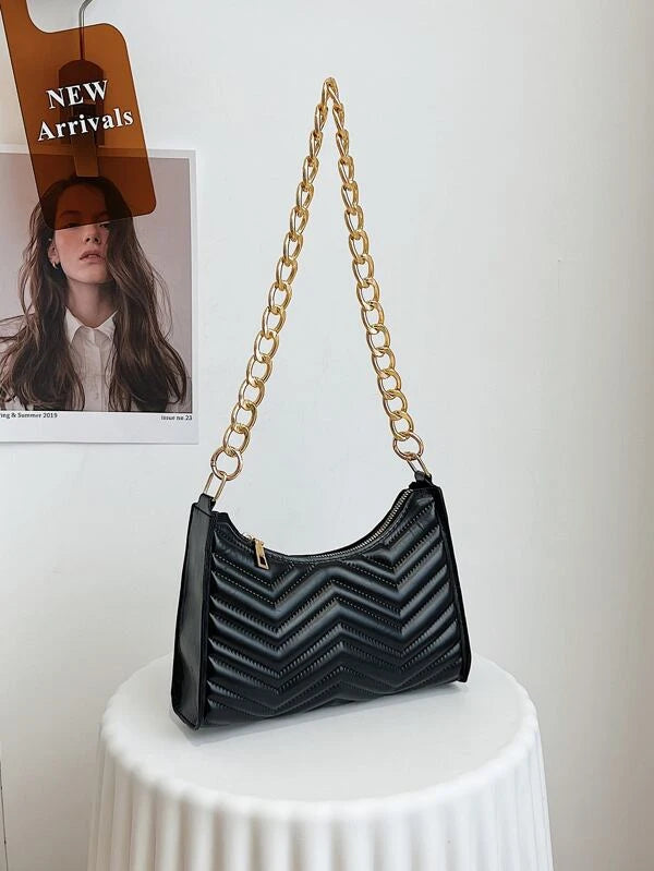 black textured bag with gold chain strap