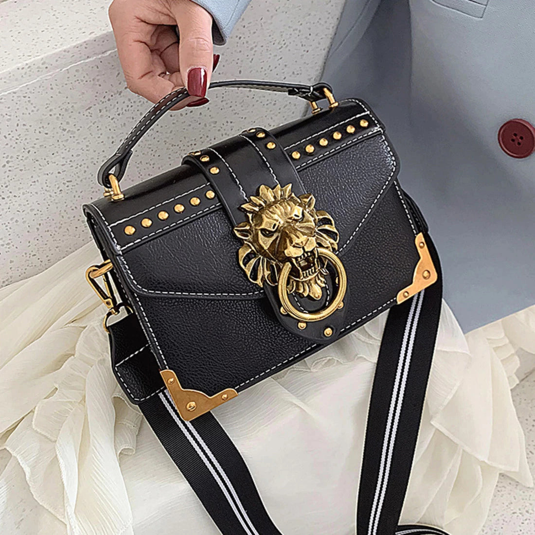 luxury bag with metal lion head detail